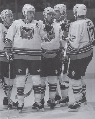 Adam Burt, Andrei Nikolishin, Geoff Sanderson, and Steven Rice celebrate a goal